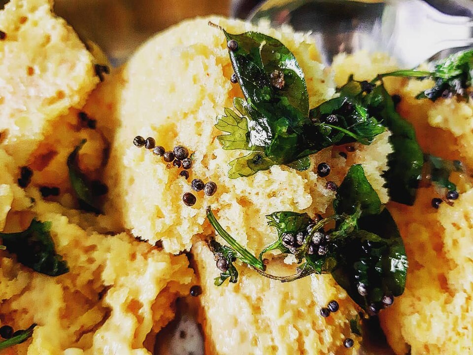 Soft yellow dhokla pieces ready to serve